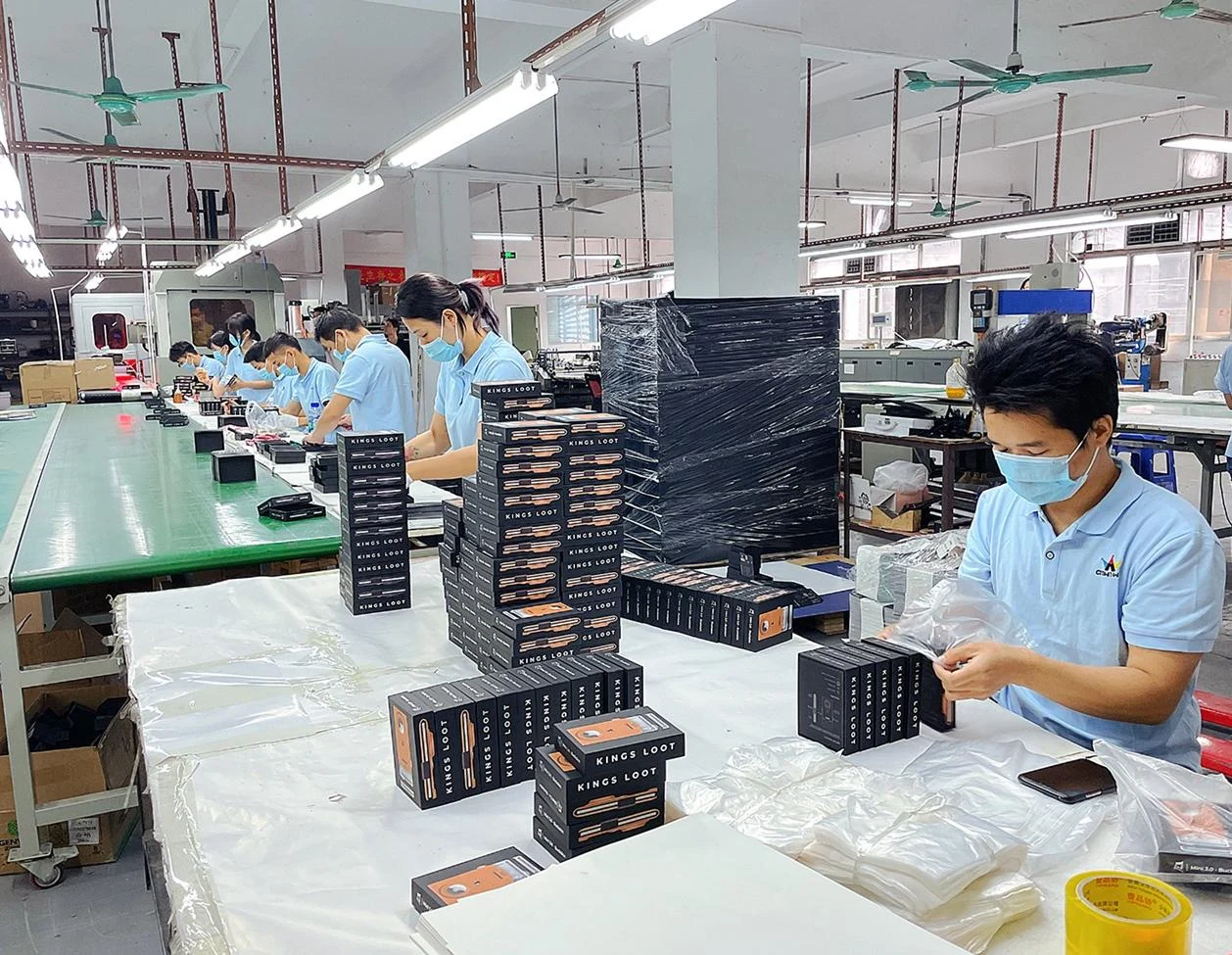 Workers checking and packing finished gift boxes